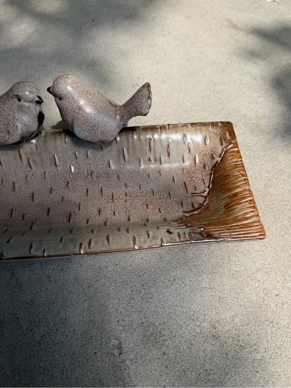 Ceramic bird feeder/tray.